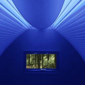 A blue light shining inside a timber pod