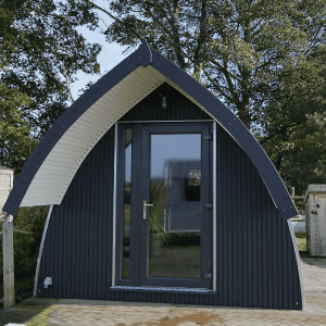 A timber pod painted black and white