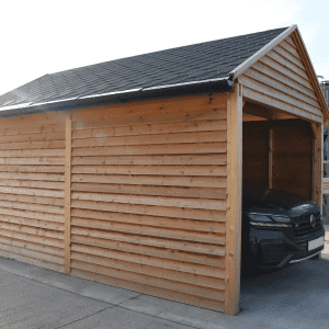 Timber garage housing a car