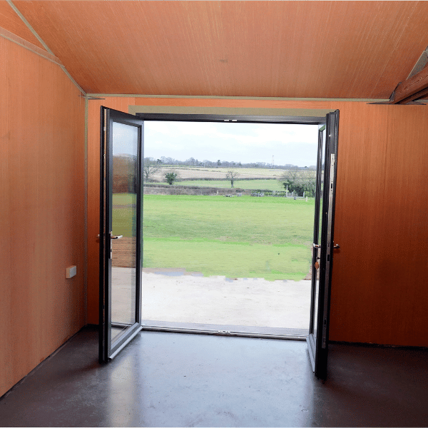 Carriage house doors open to field